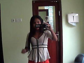 Sexy brunette Asian babe fools around with the camera