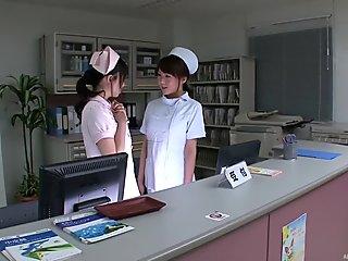 Nurses behind the desk suck on hard Japanese nipples